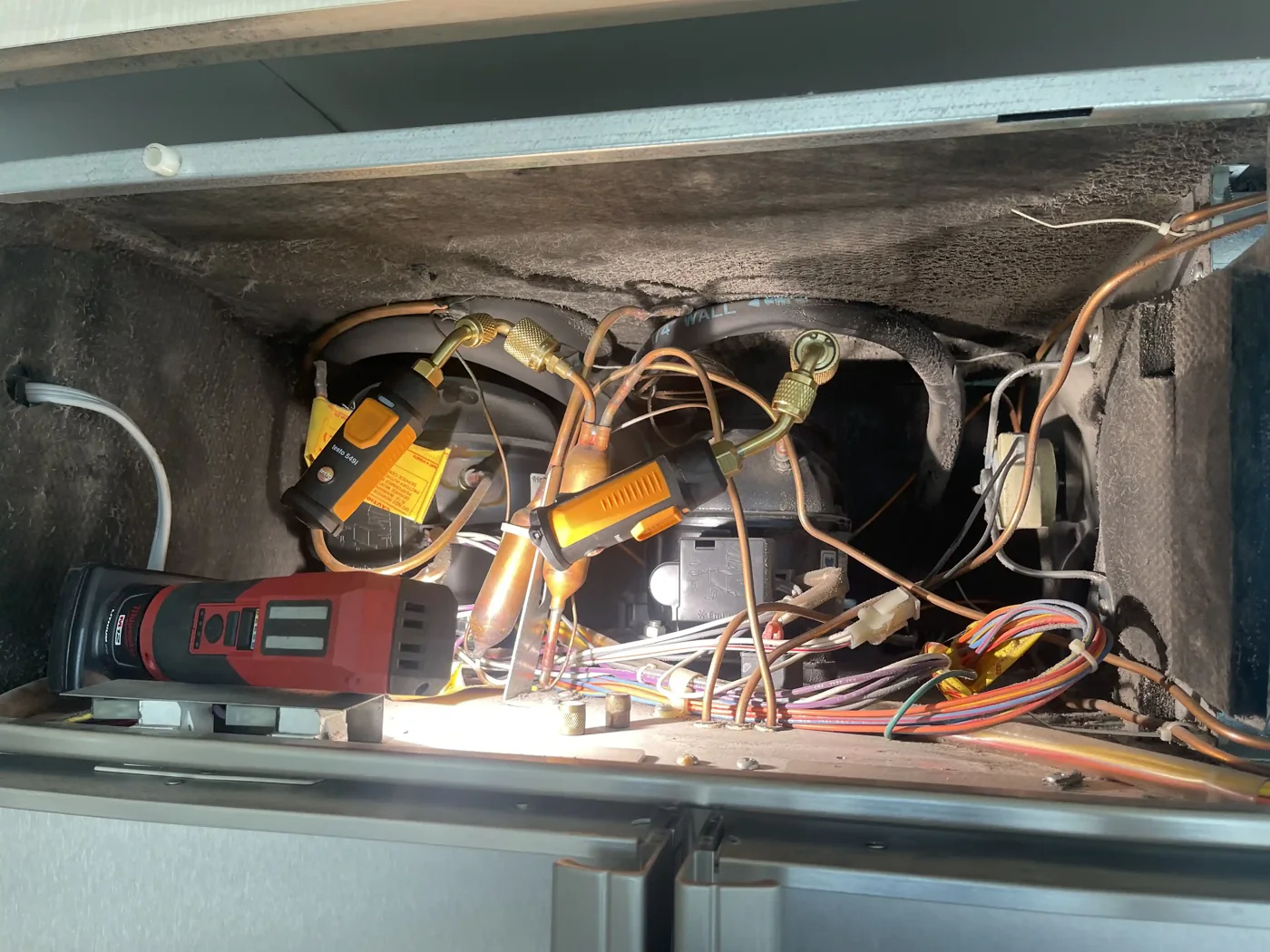Refrigerant gauges connected during a built-in refrigerator compressor diagnostic