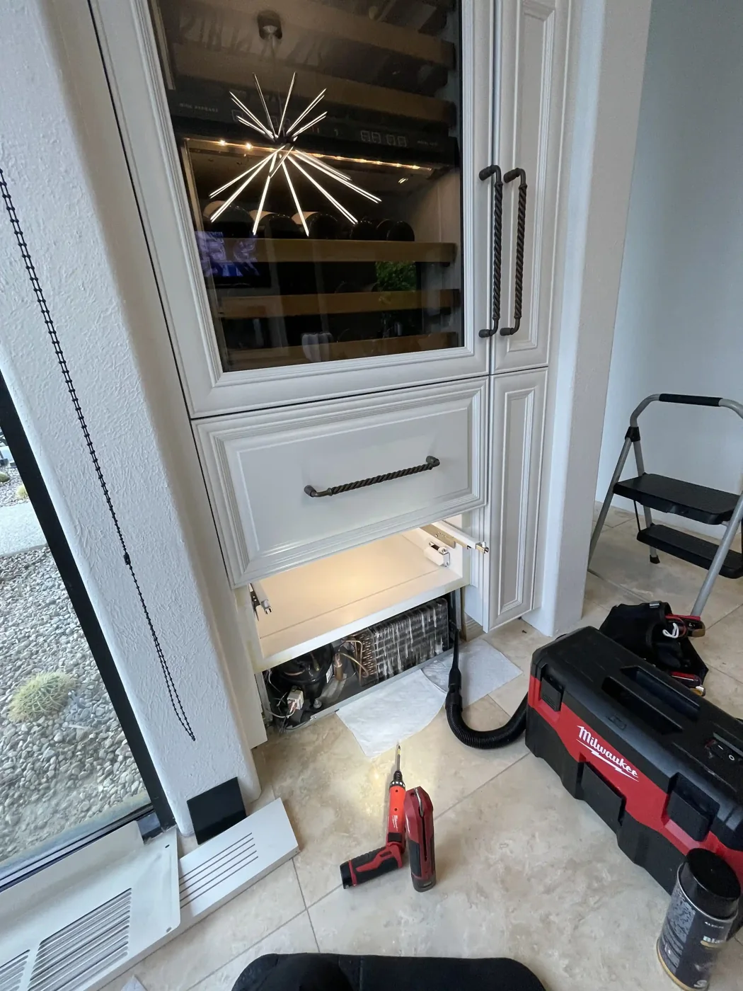 Wine storage compartment opened for service with the floor protected