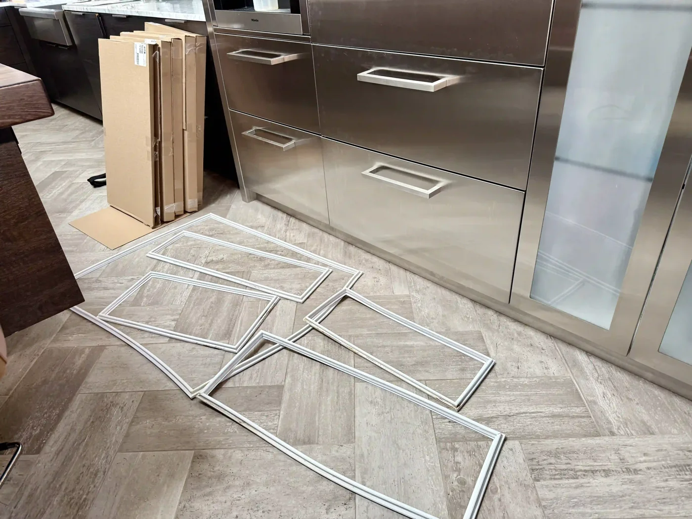 New door gaskets laid out before replacement on a built-in unit