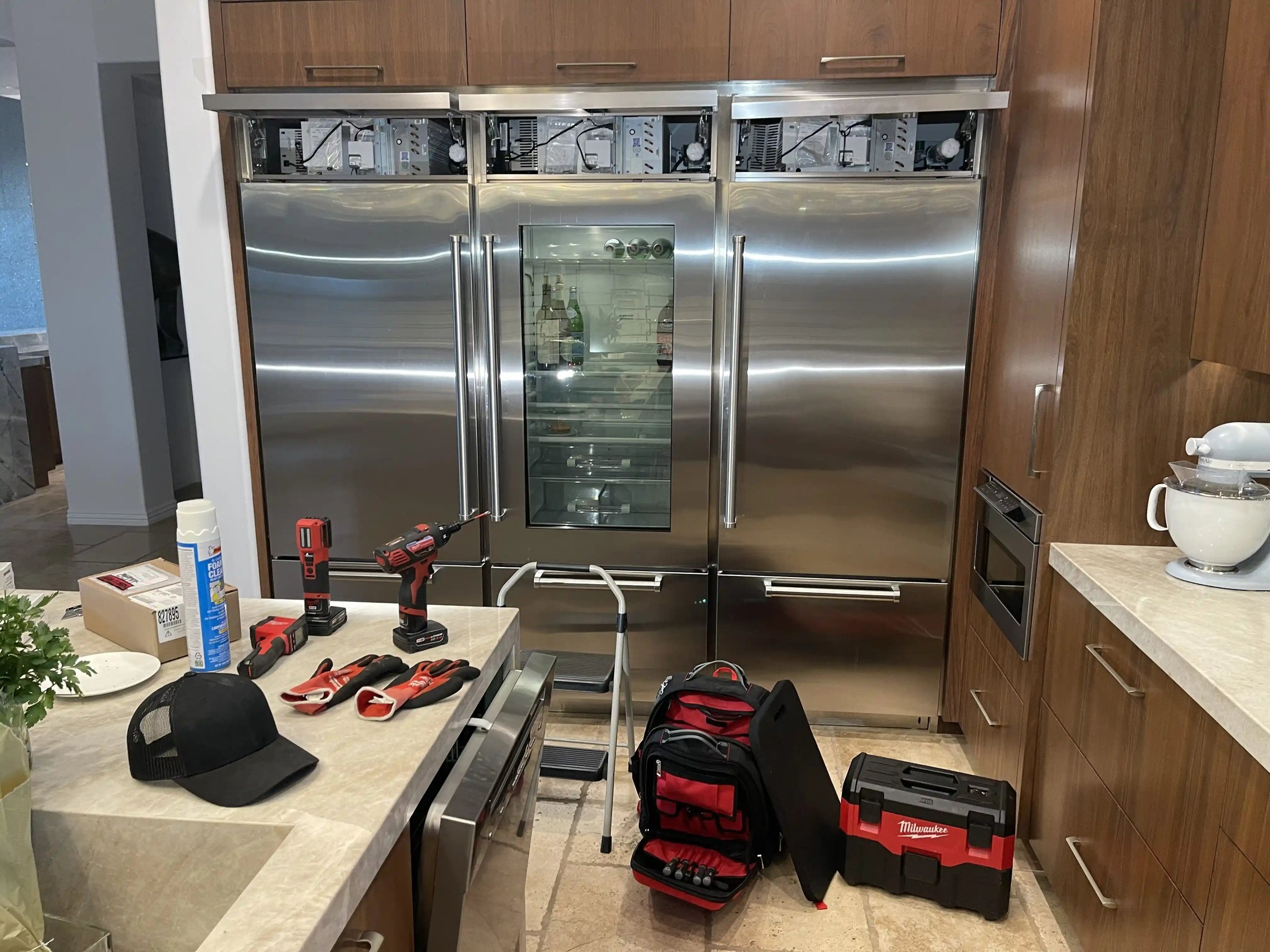 Technician performing diagnostic on a built-in refrigerator